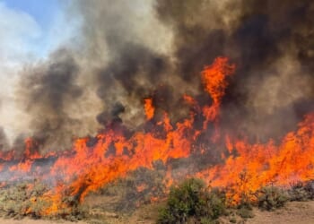 A helicopter battling a Utah wildfire crashes with no word on the 2 people aboard