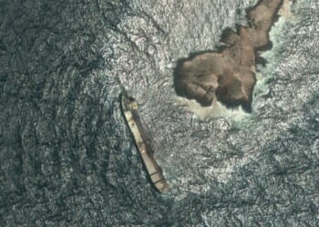 Oman says the oil spill from a grounded tanker has reached its coastline