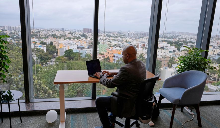 Shivaram K R, CEO of Hue Learn, works in his office with the city's skyline in the background, in Bengaluru, India, Monday, Aug. 24, 2026. (AP Photo/Aijaz Rahi)