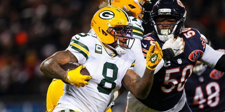 Josh Jacobs #8 of the Green Bay Packers runs the ball during an NFC Wild Card Playoff game against the Chicago Bears at Soldier Field on Jan. 10 in Chicago, Illinois.