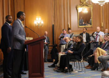 Rep. Burgess Owens (R-UT) speaks as Rep. Byron Donalds (R-FL) listens in the Rayburn Reception Room after formally unveiling the Frederick Douglass Press Gallery in the US Capitol.