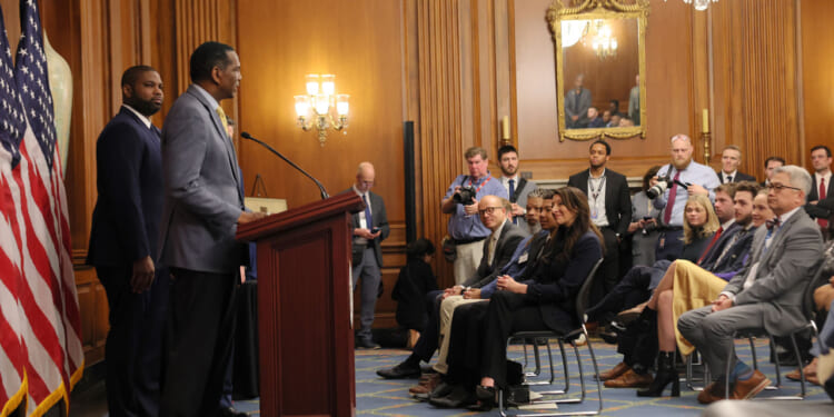 Rep. Burgess Owens (R-UT) speaks as Rep. Byron Donalds (R-FL) listens in the Rayburn Reception Room after formally unveiling the Frederick Douglass Press Gallery in the US Capitol.