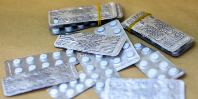 Metallic pill packets lay on a wooden table in New York on May 7, 2026.