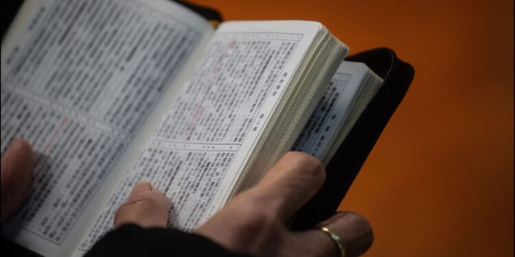 A Christian worshipper holds a Bible while attending a church service in Hong Kong on Dec. 23, 2018.