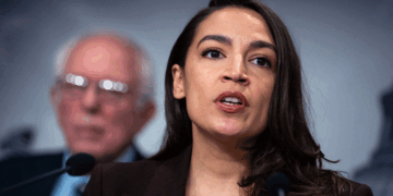Rep. Alexandria Ocasio-Cortez, D-N.Y., speaks during a news conference with Sen. Bernie Sanders, I-Vt., to announce the Artificial Intelligence Data Center Moratorium Act in the U.S. Capitol on Wednesday, March 25, 2026. The legislation aims to "ensure that AI benefits workers, is safe and effective and does not harm communities or destroy the environment." (Tom Williams/CQ-Roll Call, Inc via Getty Images)