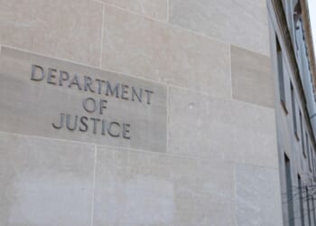 The DoJ Building is pictured on a bright sunny day.