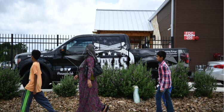 People walk to a Mosque in Stafford, Texas, for the funeral of Santa Fe High School shooting victim Sabika Sheikh, 17, on May, 20, 2018.