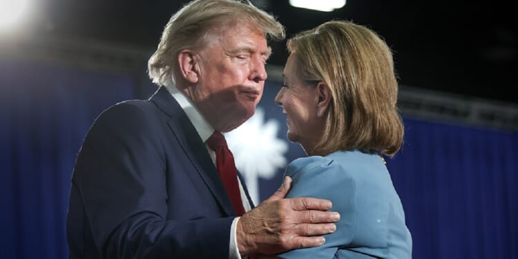 President Donald Trump hugs U.S. Sen. Darline Graham at an Aug. 21 campaign rally for Graham in Myrtle Beach, South Carolina.