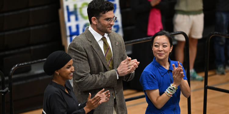 Ilhan Omar and Hasan Piker stand with Wisconsin gubernatorial candidate Francesca Hong during a campaign rally.