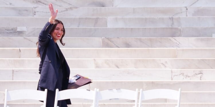 Rep. Alexandria Ocasio-Cortez waves as she arrives to speak during a "Defend the Vote" rally at the Lincoln Memorial in Washington, D.C., on Aug. 28, 2026, coinciding with the 63rd anniversary of the 1963 "March on Washington" rally for civil rights.