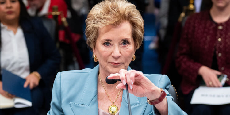 The Department of Education just sent a "Dear Colleague" letter reversing previous disparate impact guidelines on punishment in education. Pictured: Education Secretary Linda McMahon, a woman in a light blue suit speaks at a microphone during a formal meeting, with people seated and blurred in the background.