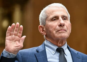 Anthony Fauci stands with his right hand in the air as he takes the oath before entering a hearing for the Senate Homeland Security Committee on July 29, 2026.
