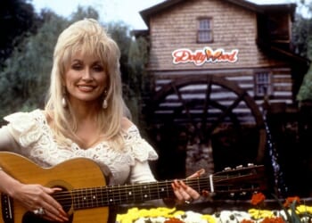 Dolly Parton holds her guitar outside of Dollywood in 1993 in Pigeon Forge, Tennessee.