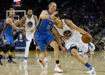 Klay Thompson #11 of the Golden State Warriors drives past Kyle Singler #15 of the Oklahoma City Thunder at Oracle Arena on Nov. 3, 2016, in Oakland, California.