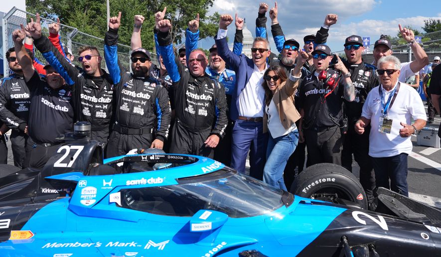 Transportation Secretary Sean Duffy joins for a photo after Kyle Kirkwood (27) won the IndyCar Freedom 250 Grand Prix auto race in Washington, Sunday, Aug. 23, 2026. (AP Photo/Alex Brandon)