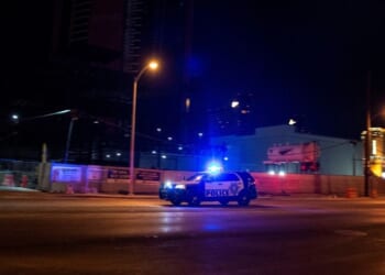 A police car makes it way to the scene of shooting in downtown Las Vegas on June 1, 2020.