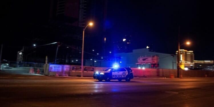 A police car makes it way to the scene of shooting in downtown Las Vegas on June 1, 2020.