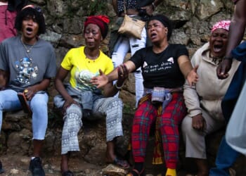 Haitians react in grief following overnight violence where more than 40 people were killed by armed gangs in Kenscoff, a neighborhood near Port-au-Prince, Haiti.
