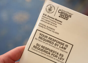 A close-up of a 2020 U.S. Census Bureau envelope with text stating, YOUR RESPONSE IS REQUIRED BY LAW in English and Spanish.