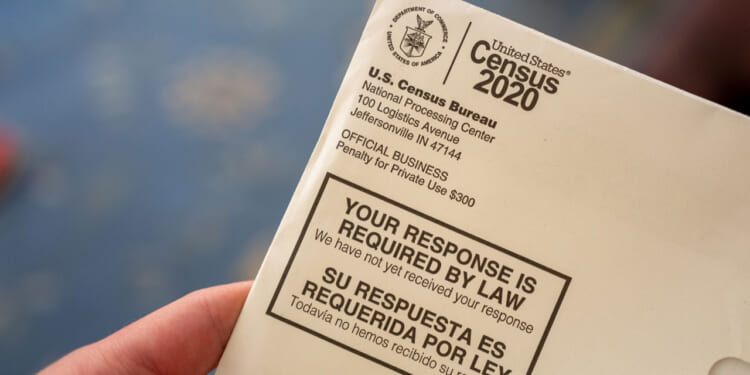 A close-up of a 2020 U.S. Census Bureau envelope with text stating, YOUR RESPONSE IS REQUIRED BY LAW in English and Spanish.
