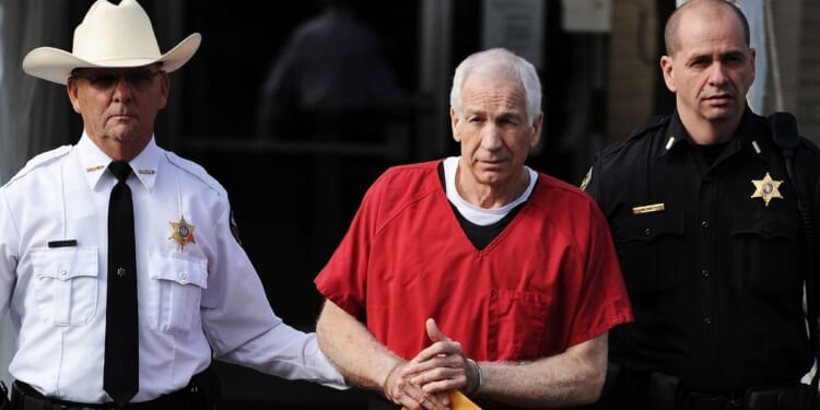 Former Penn State assistant football coach Jerry Sandusky leaves the Centre County Courthouse after being sentenced in his child sex abuse case on Oct. 9, 2012, in Bellefonte, Pennsylvania.