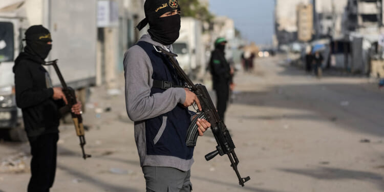 Members of Palestinian Hamas's Ezzedine Al-Qassam Brigades and Islamic Jihad's Quds Brigades are deployed at intersections for Eid al-Fitr prayers.