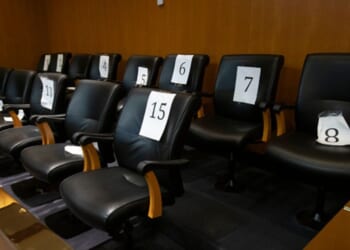 An empty jury box is pictured in a courtroom with numbered seats inside on February 6, 2024 in Pontiac, Michigan.