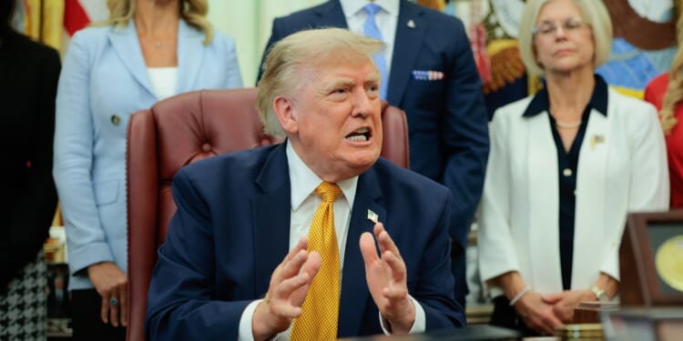 President Donald Trump speaks to the media after signing an executive order establishing the President's Military Spouse Commission in the Oval Office at the White House on Aug. 3, 2026, in Washington, D.C.