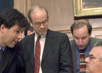 Rep. Barney Frank reads the morning paper and confers with Minority Chief Counsel Julian Epstein before the start of the House of Representatives Judiciary Committee's impeachment inquiry of President Bill Clinton.