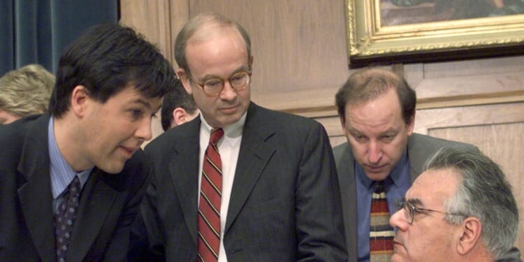 Rep. Barney Frank reads the morning paper and confers with Minority Chief Counsel Julian Epstein before the start of the House of Representatives Judiciary Committee's impeachment inquiry of President Bill Clinton.