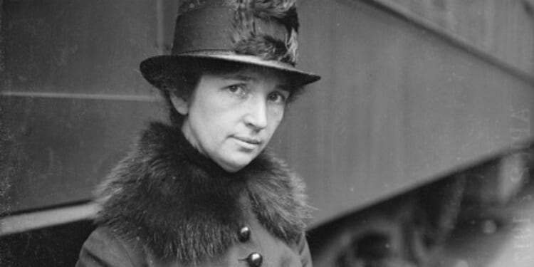 Margaret Sanger is pictured standing near a train in Chicago circa 1917.