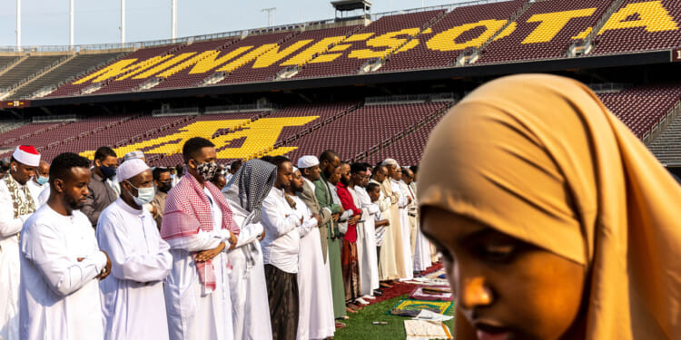 Muslim worshippers gather at the Huntington Bank Stadium during Eid al-Adha prayers and festivities.