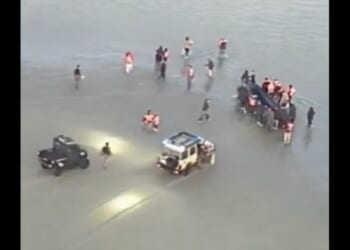 French police wrangle with illegal immigrants atempting to launch from France to cross the English Channel to the U.K. in undated video footage.