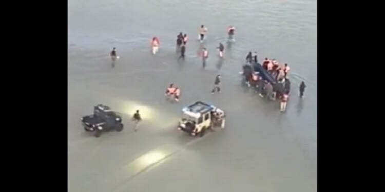 French police wrangle with illegal immigrants atempting to launch from France to cross the English Channel to the U.K. in undated video footage.