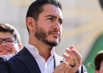 Michigan Democratic Senate primary winner Abdul El-Sayed claps during a news conference Wednesday after his victory over Rep. Haley Stevens.