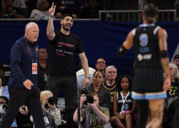 Former NBA player Enes Kanter Freedom gets in a dispute on Sunday with the the Chicago Sky's Natasha Cloud during a Sky-Indiana Fever WNBA game at Chicago's Wintrust Arena.