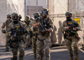 Immigration and Customs Enforcement agents run out of Delaney Hall Immigration Detention Center as they protect vehicles during a shift change on June 7, 2026, in Newark, New Jersey.