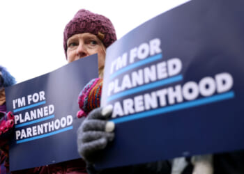 Boston, MA - November 12: Demonstrators held signs during a Planned Parenthood rally outside of the Moakley Federal Courthouse on November 12, 2025. (Photo by Jessica Rinaldi/The Boston Globe via Getty Images)