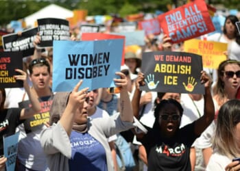 A gathering outside the Trump hotel building emerges to protest Republican policy on June 28, 2018.