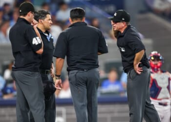 Umpires gather to review a play during the seventh inning of the MLB game between the Toronto Blue Jays and the Boston Red Sox at Rogers Centre on Aug. 10, 2026, in Toronto, Ontario, Canada.