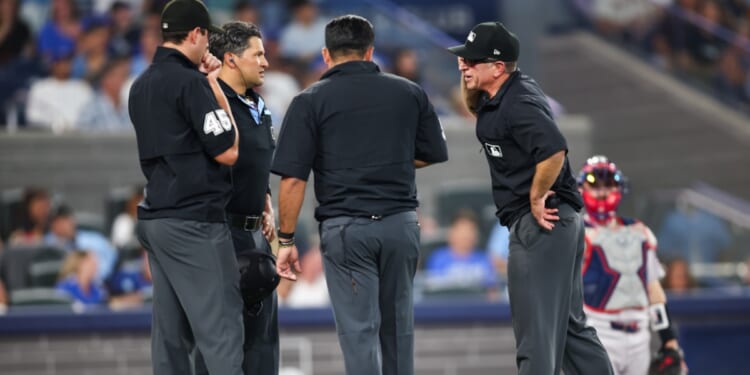Umpires gather to review a play during the seventh inning of the MLB game between the Toronto Blue Jays and the Boston Red Sox at Rogers Centre on Aug. 10, 2026, in Toronto, Ontario, Canada.