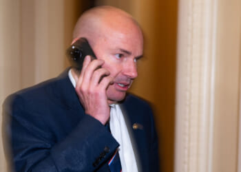 Sen. Mike Lee speaks on his phone.