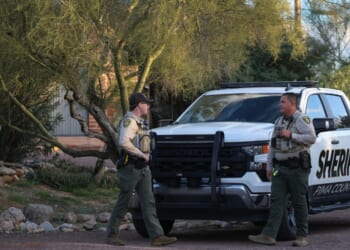 Pima County Sheriff's deputies are seen in front of Nancy Guthrie's residence during a shift change on Feb. 19, 2026, in Tucson, Arizona.