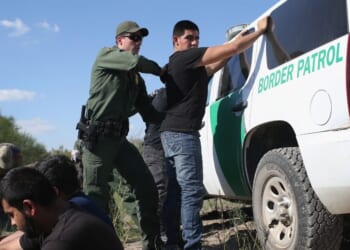A U.S. Border Patrol officer searches an illegal immigrant near the U.S.-Mexico border on Dec. 7, 2015 in Rio Grande City, Texas.