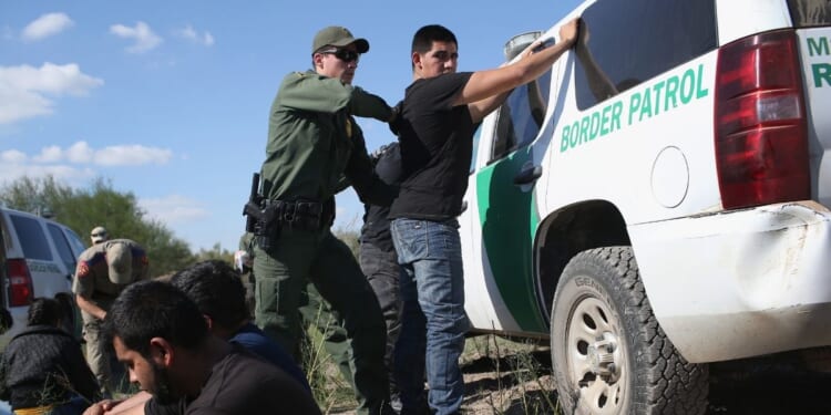 A U.S. Border Patrol officer searches an illegal immigrant near the U.S.-Mexico border on Dec. 7, 2015 in Rio Grande City, Texas.