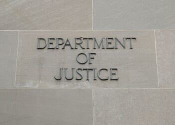 The Department of Justice logo is showcased on the side of a building.
