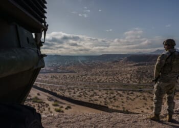 A U.S. Army soldier stands next to a Stryker armored infantry transport vehicle, which has been deployed along the U.S.-Mexico border as part of the military's Joint Task Force Southern Border mission, in Sunland Park, New Mexico, on April 4, 2025.