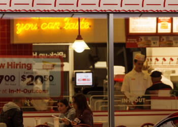 A "Now hiring" sign is displayed on the window of a fast food restaurant in Encinitas, California, May 9, 2022. REUTERS/Mike Blake/File Photo