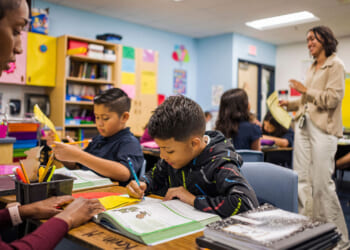 Aisha Thomas (L) learns teaching skills with teacher Alexxa Martinez, in her classroom in Nevitt Elementary School, in Phoenix, Arizona, on October 26, 2022. - Teachers in Arizona are among the United States' lowest paid, making the cost-of-living crisis even more acute for educators in this key battleground for the upcoming mid-term elections. (Photo by Olivier TOURON / AFP) (Photo by OLIVIER TOURON/AFP via Getty Images)