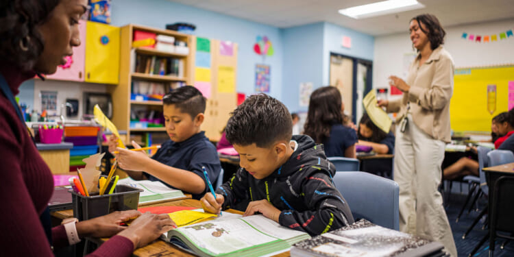 Aisha Thomas (L) learns teaching skills with teacher Alexxa Martinez, in her classroom in Nevitt Elementary School, in Phoenix, Arizona, on October 26, 2022. - Teachers in Arizona are among the United States' lowest paid, making the cost-of-living crisis even more acute for educators in this key battleground for the upcoming mid-term elections. (Photo by Olivier TOURON / AFP) (Photo by OLIVIER TOURON/AFP via Getty Images)